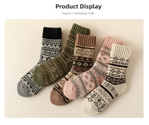 Close-up of five pairs of thick wool socks with Nordic Fair Isle patterns and ribbed cuffs
