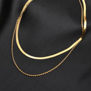 Double-layered 18k gold plated flat snake and twist chain necklace on black silk