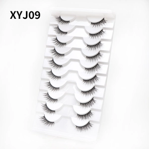 Close-up of 10 pairs of XYJ09 cat-eye false eyelashes in a white plastic tray