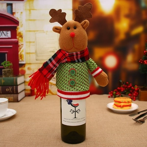 Detail of knitted Christmas reindeer wine bottle cover with festive red scarf and green buttons