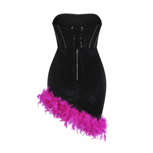 Close-up of black velvet corset dress featuring pink ostrich feather hem and front zipper