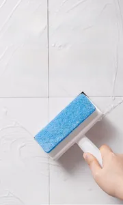 2-in-1 glass cleaning brush with sponge and squeegee removing foam from wall tiles