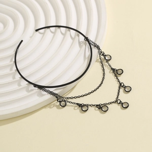 Macro view of black gothic multilayer chain bracelet with sparkling crystal pendants