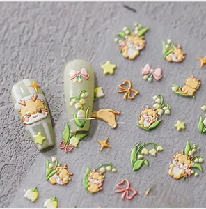 Detailed macro view of 5D embossed nail stickers with lily of the valley and deer motifs