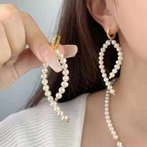 Elegant gold S925 silver baroque pearl drop earrings paired with a matching necklace