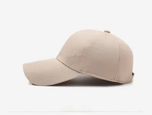 Side view of beige baseball cap featuring embroidered Sport logo and long curved brim