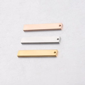 Detailed view of rectangular stainless steel pendants in gold, silver and rose gold