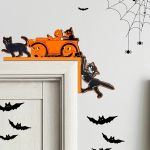 Close-up of Halloween wooden door corner decor with black cat and pumpkin carriage