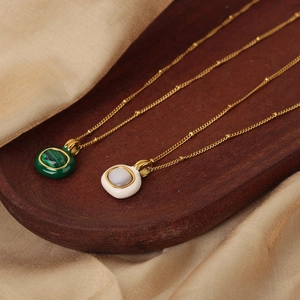 Vintage gold plated pendant necklace with malachite green and white shell inserts