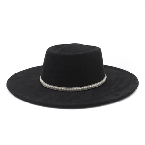 Detail of white faux pearl decorative band on black wide brim fedora hat