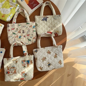 Quilted cotton handheld phone bags with cute animal patterns on a wooden table