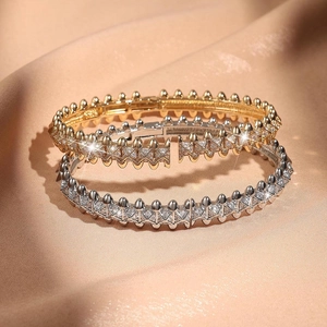 Detail von luxuriösen geometrischen Spike-Armbändern mit Kristallen in Gold und Silber