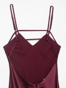 Detail of burgundy satin dress showing the V-back design and adjustable spaghetti straps