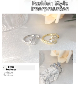 Detailed view of silver and gold star rings with micro-set stones on silk fabric