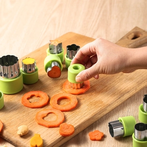12-piece stainless steel vegetable cutter set with green handles for fruit and cookies