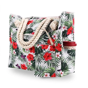 Detail of tropical floral beach tote featuring hemp rope handles and a practical side pocket