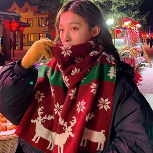 Festive red knit scarf featuring white reindeer and snowflake patterns for Christmas