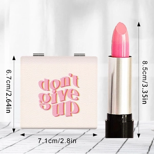 Portable folding makeup mirror with pink lipstick and compact case on grid background