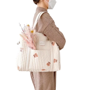 Off-white quilted cotton mommy tote bag with animal embroidery and fabric handles