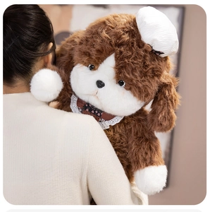 Close-up of fluffy puppy plush toy with lace bib held by model for cozy comfort