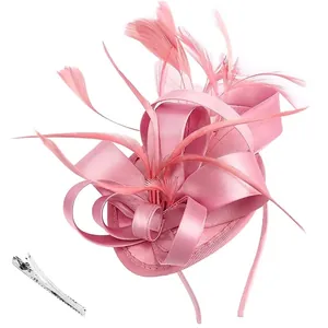 Close-up of pink fascinator with feathers, satin ribbon, and silver metal hair clip