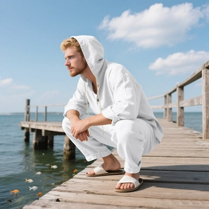 Close-up of white linen hooded shirt and pants texture in a seaside setting