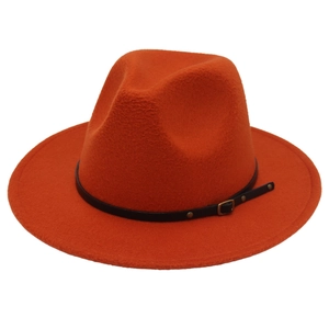 Close-up of orange wool fedora hat featuring a black leather band and retro metal buckle
