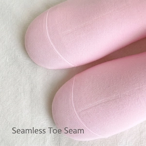 Close-up of pink cotton crew socks featuring seamless toe design and fine knit texture