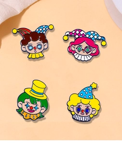 Macro detail of four circus clown enamel pins with vibrant colors for backpacks and shirts