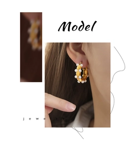Close-up of gold-plated hoop earrings with high-luster shell pearls on a model