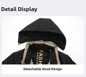 Detail of detachable hood design on a black men's winter jacket with zipper connection