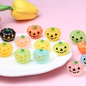 Colorful luminous resin pumpkin ornaments for DIY Halloween decorations on white plate