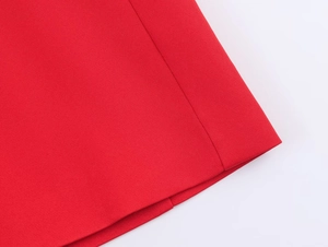 Detailed macro view of red twill fabric texture and professional stitching on the suit set
