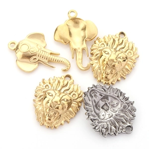 Detailed macro view of vintage stainless steel lion and elephant head animal pendants