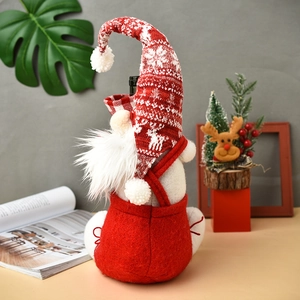 Christmas gnome wine bottle cover with red knit snowflake hat and white reindeer patterns