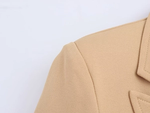 Detailed close-up of khaki blazer lapel and shoulder showing premium fabric texture