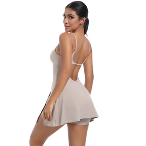 Beige backless sports dress with thin straps and built-in shorts for tennis and golf