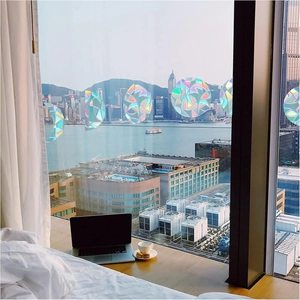 Rainbow prism window film showing suncatcher effect on glass with ocean city view