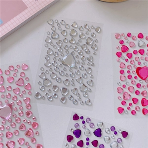 Flat lay of colorful heart-shaped crystal rhinestone stickers in multiple sizes and shades
