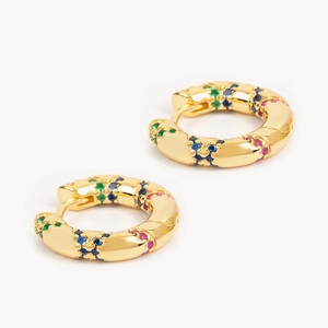 Detailed view of golden hoop earrings featuring vibrant red, blue, and green zircon stones