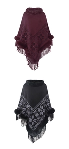 Close-up of knit poncho with snowflake patterns, fur collar and tassel hem details