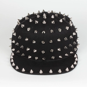 Detail of punk style flat brim snapback with silver metal spiked rivets on black canvas