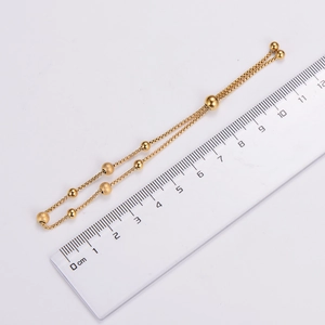 Adjustable gold beaded bracelet with polished and frosted beads shown with measurement