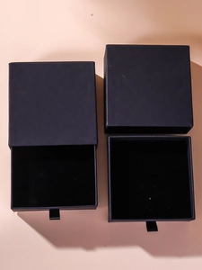 Detail of minimalist black drawer-style jewelry gift box with soft velvet lining