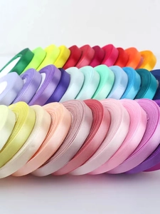 Close-up of stacked colorful 1cm satin ribbons for gift wrapping and hair styling