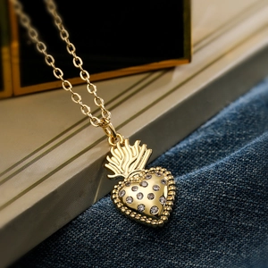 Exquisite 18K gold plated heart necklace with zircon crown on blue denim background