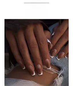 Detailed view of long ballerina nails with brown gradient and white French tips style