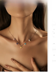 Detail of multi-colored enamel heart pendants on a 925 sterling silver chain necklace