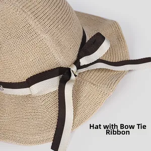 Detailed view of the striped bow ribbon on this elegant beige woven straw sun hat