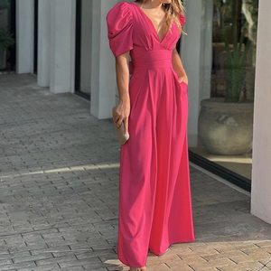 Close-up of rose red wide-leg jumpsuit with V-neck and puff sleeves on outdoor model